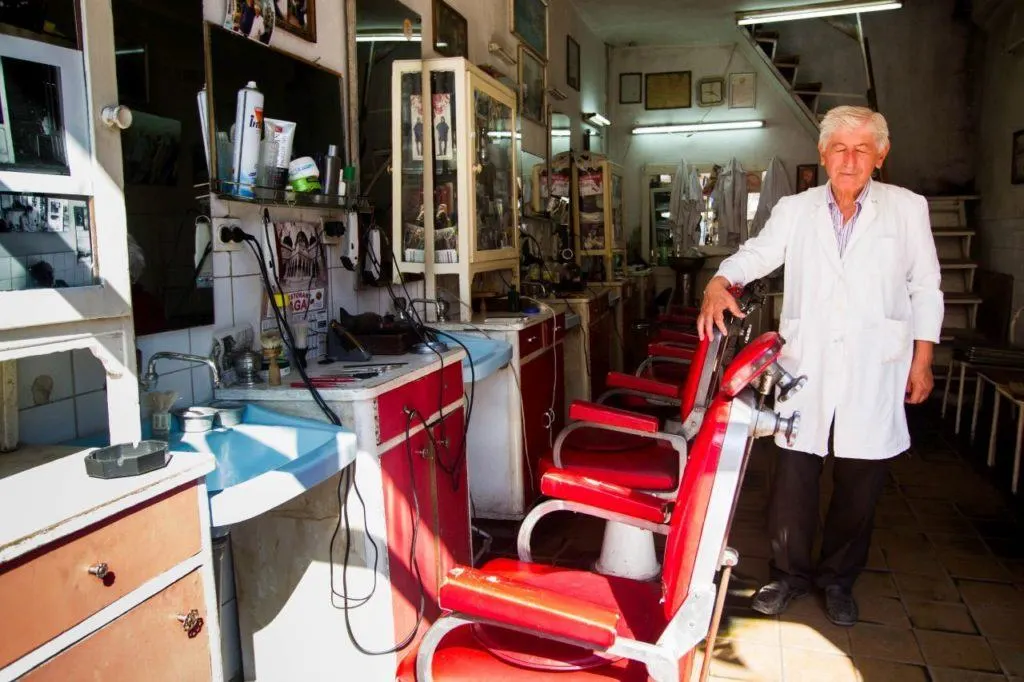 Visit Skopje, Macedonia and see a barber like this in his small shop.