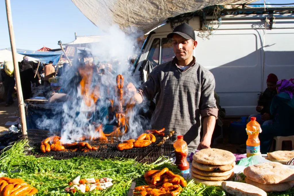 A Berber Market vendor grilling lamb merguez sausages.