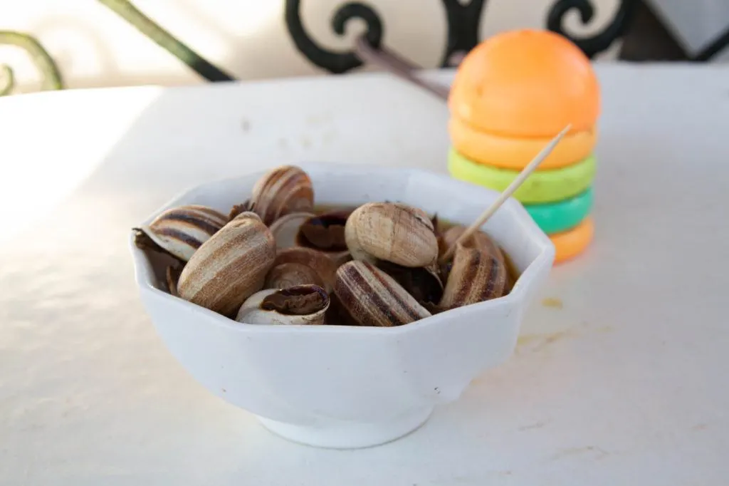 A bowl of steamed snails served in their own broth.