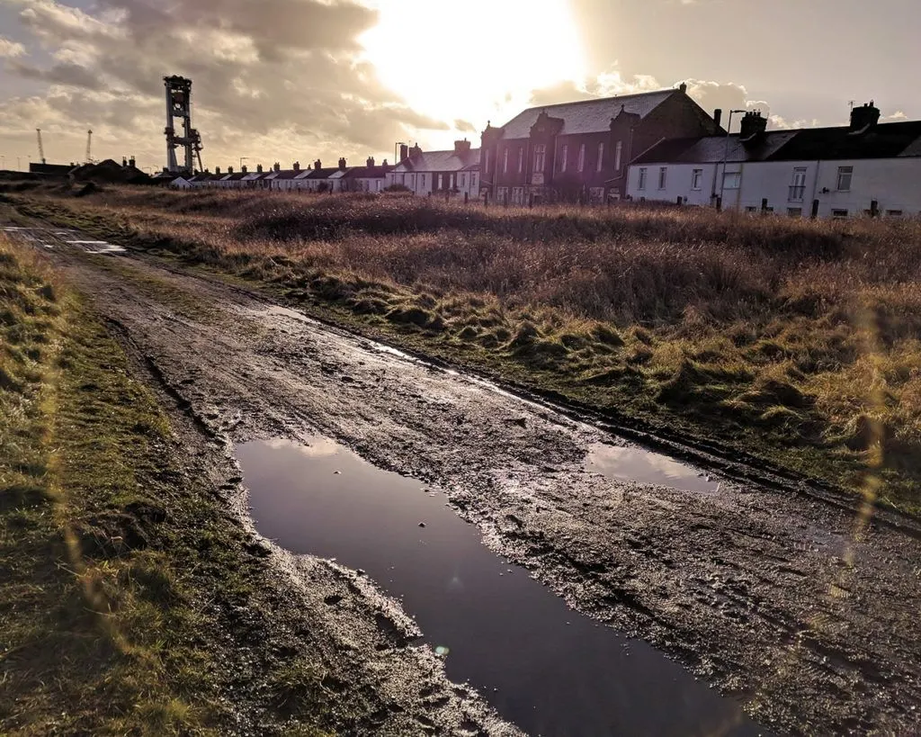 A muddy road at sunset in England.