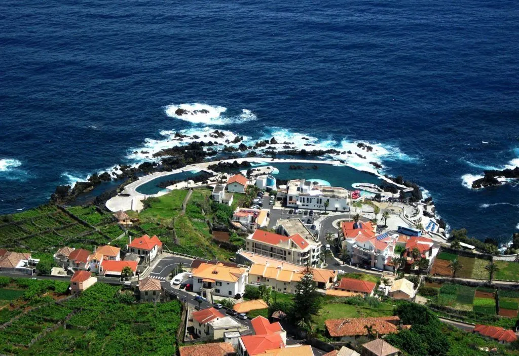 Blue waters and a small hamlet in Madeira, Portugal.