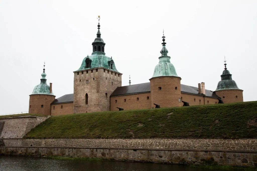 Exterior side view of Kalmar castle with canon on the walls.