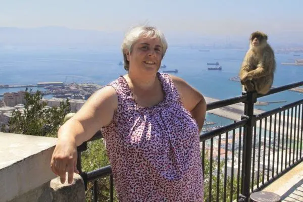 Corinne poses with a Barbary ape high up on the rock of Gibraltar.