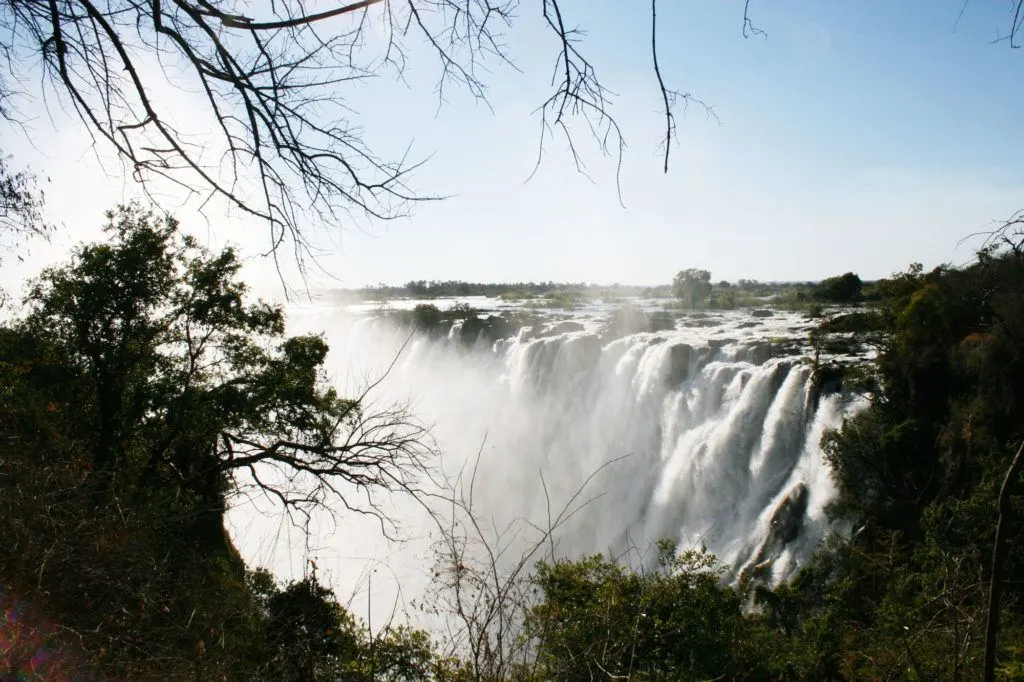 A cloud of mist rises up as an incredible amount of water from the Zambezi River flows over Victoria Falls in Zambia.